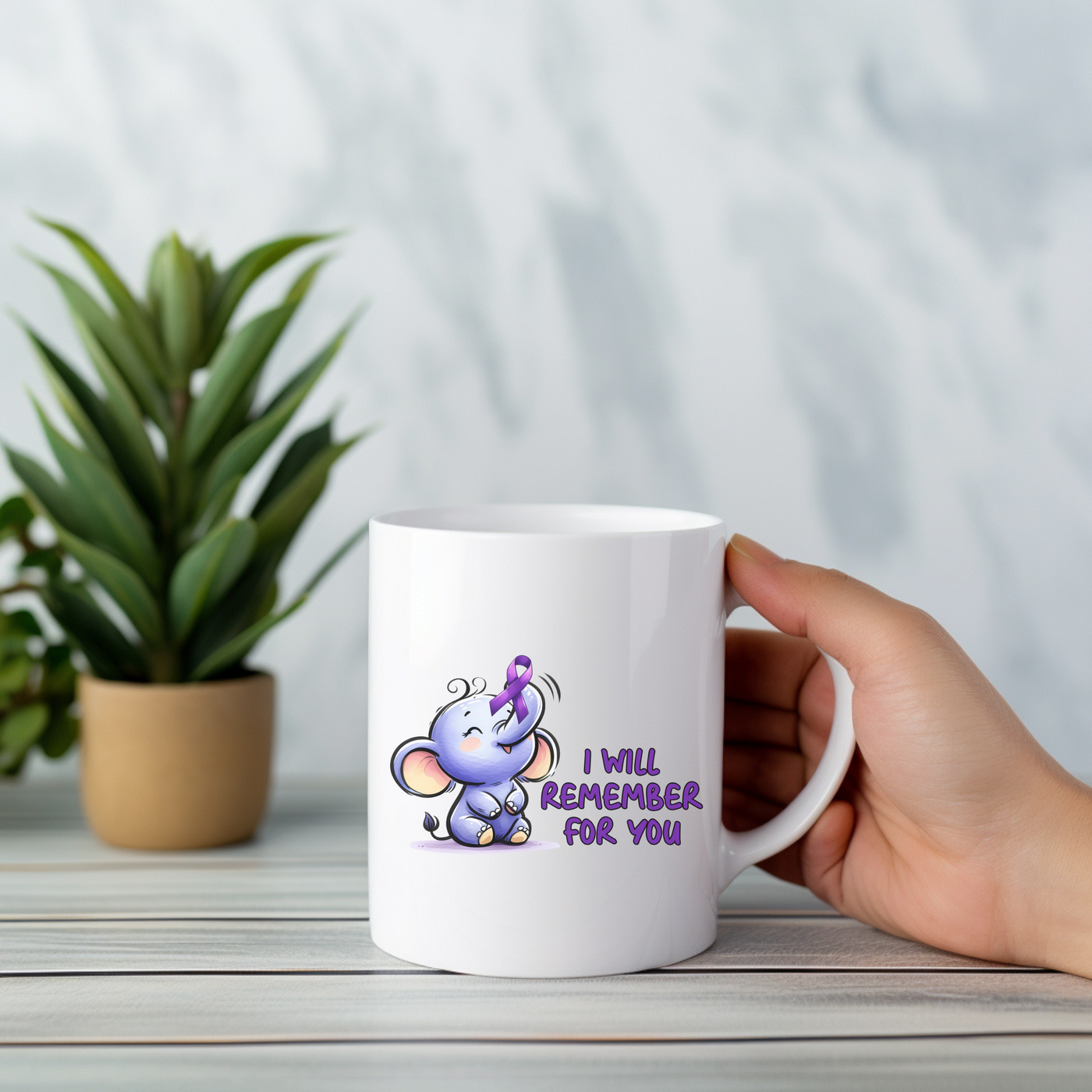 a person holding a coffee mug with a cartoon elephant on it