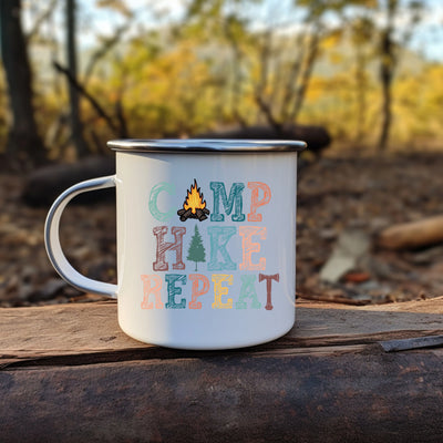 a camp hike mug sitting on top of a piece of wood