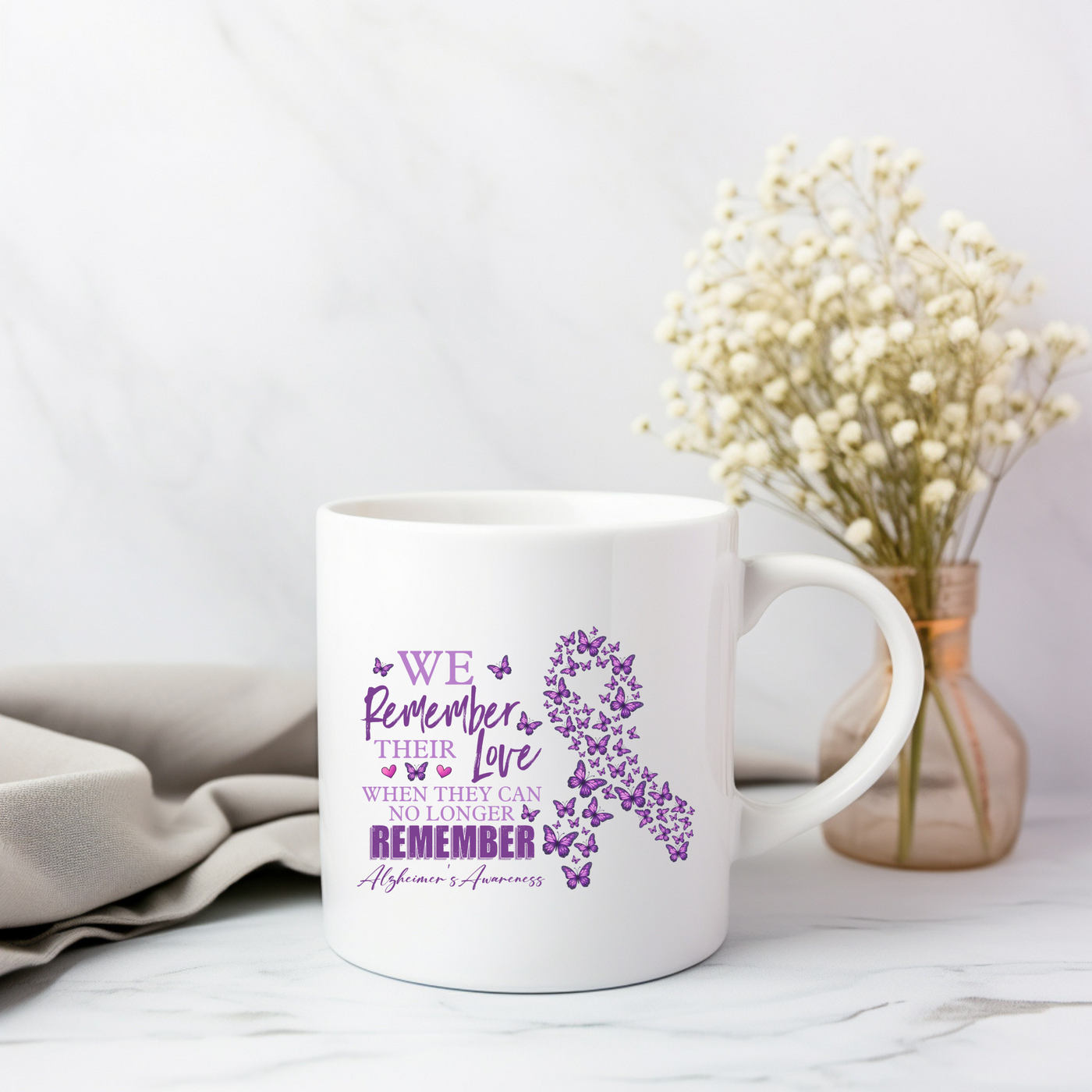 a white coffee mug with a purple ribbon on it