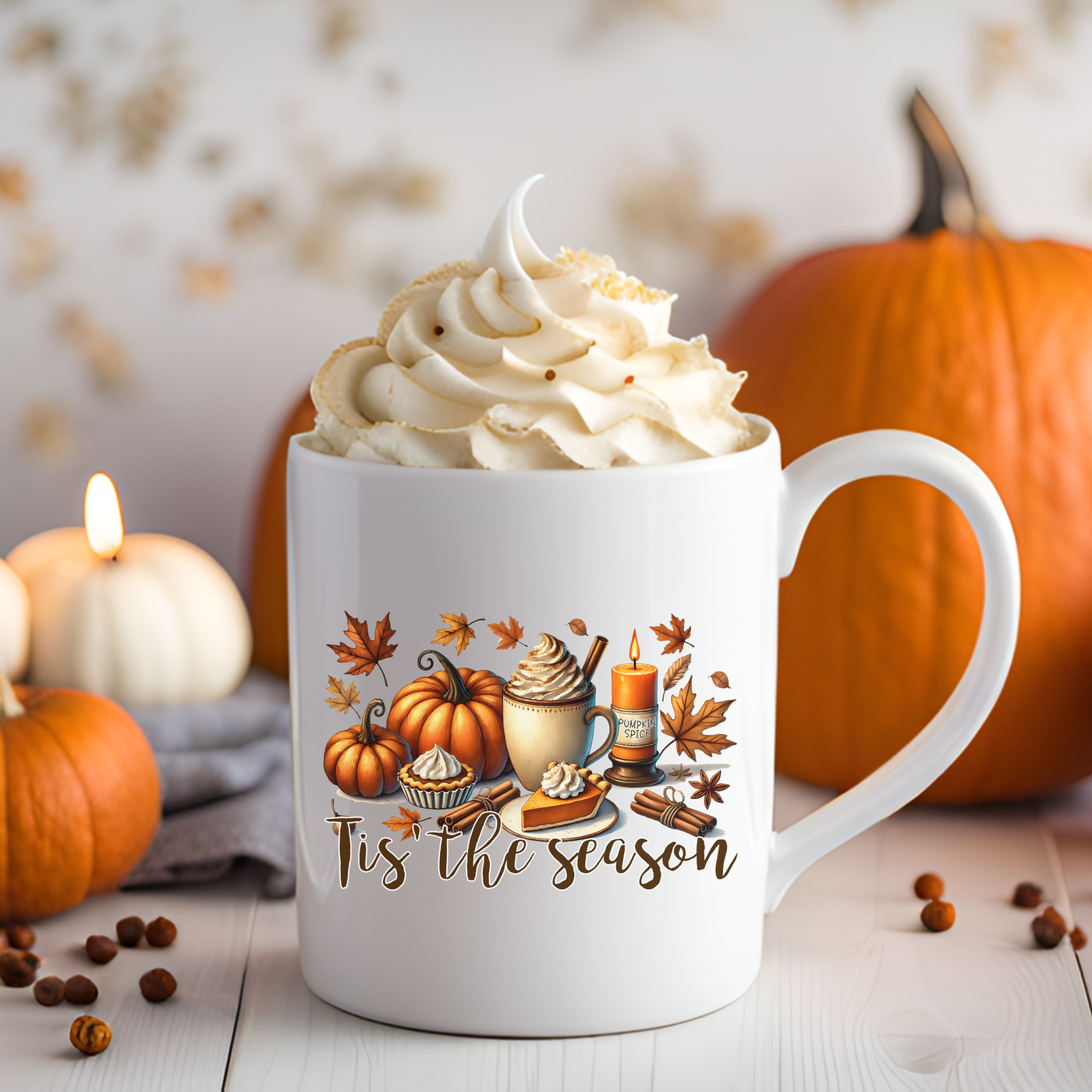 a cup of coffee with whipped cream and pumpkins in the background