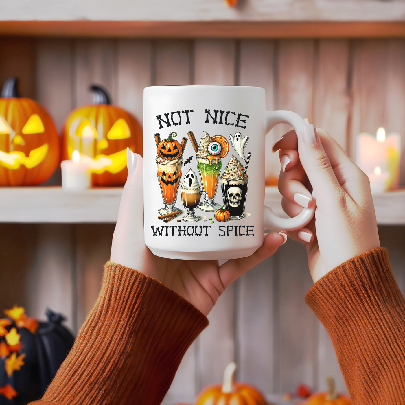 a person holding a coffee mug with halloween decorations on it