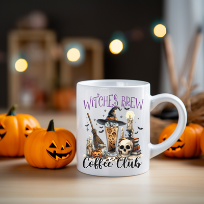 a white coffee mug with witches brew on it