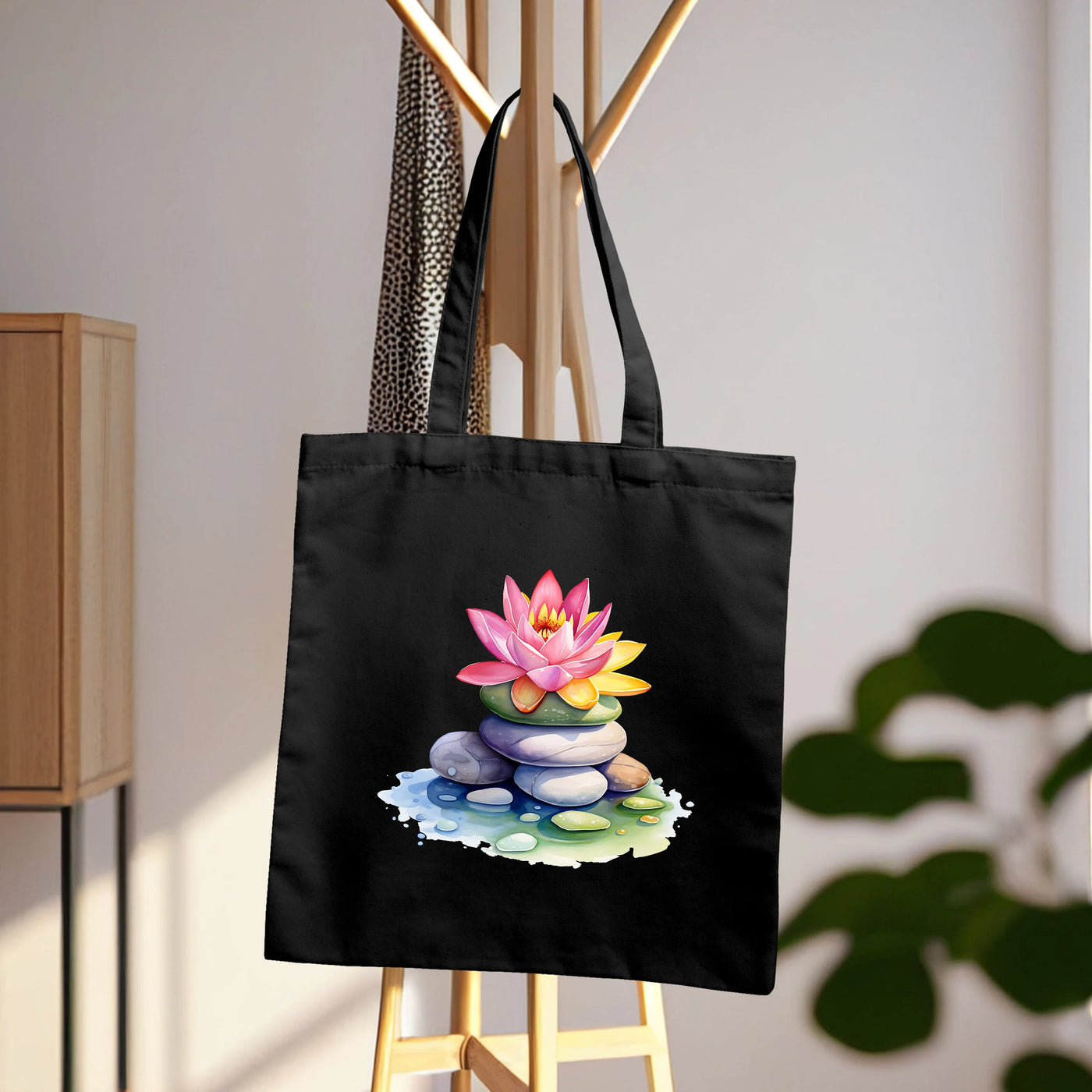 a black tote bag with a picture of a lotus flower on it