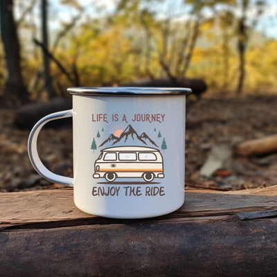 a camper mug sitting on top of a log