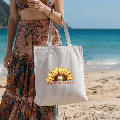 a woman standing on a beach holding a white bag