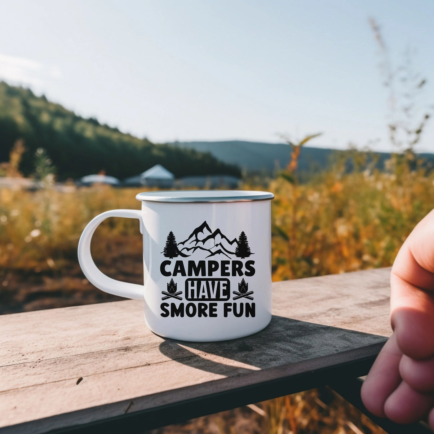 a camper's camper's cave coffee mug sitting on a picnic