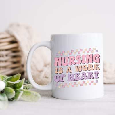 a white coffee mug with the words nursing is a work of heart