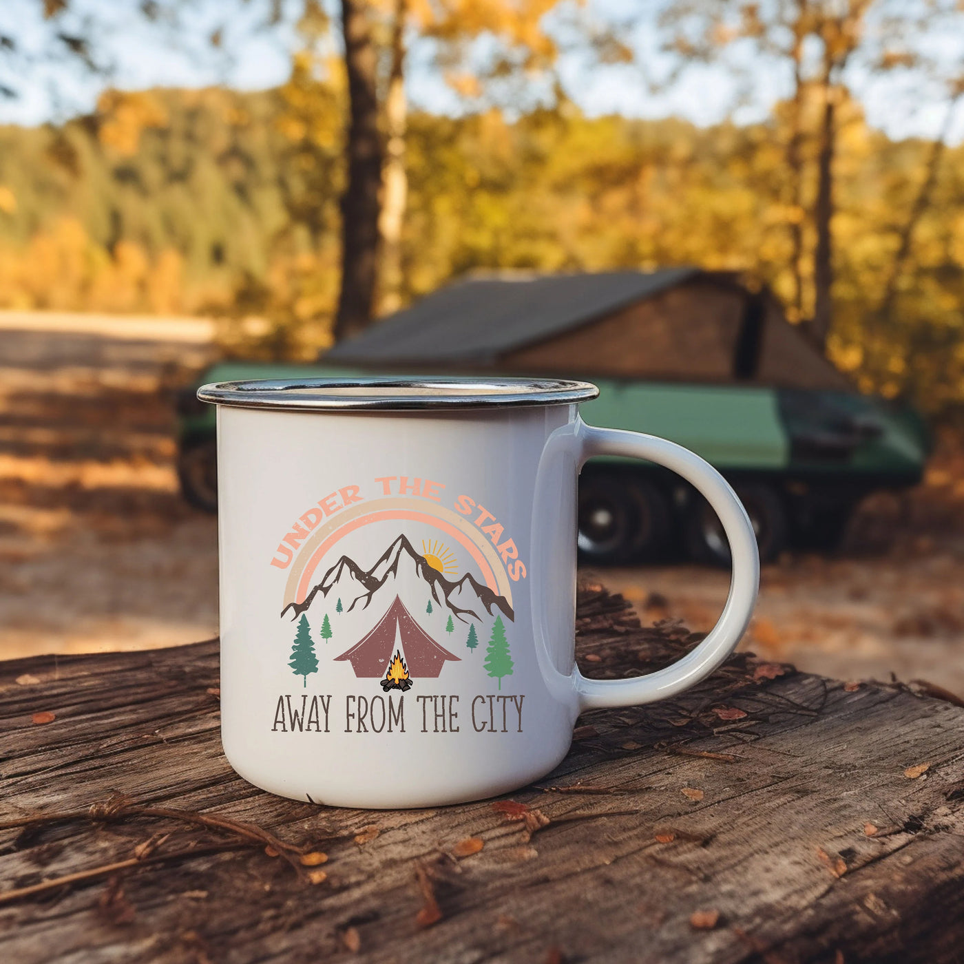 a camper mug sitting on a log in the woods