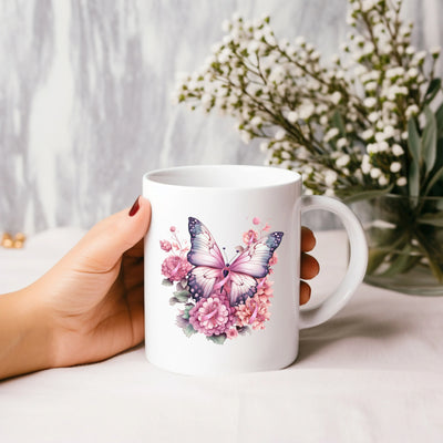 a person holding a coffee mug with a butterfly on it