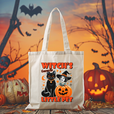 a white tote bag with a black cat and a ghost on it