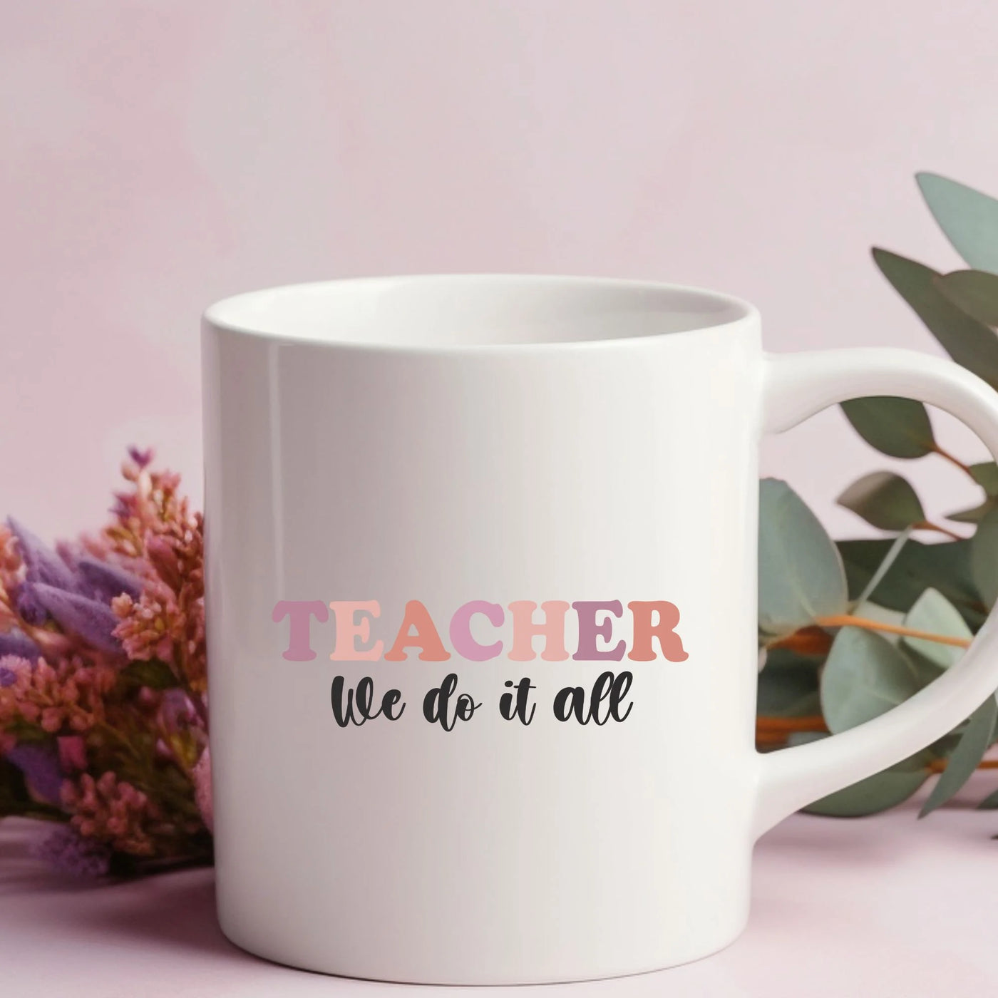 a white coffee mug with the words teacher we do it all