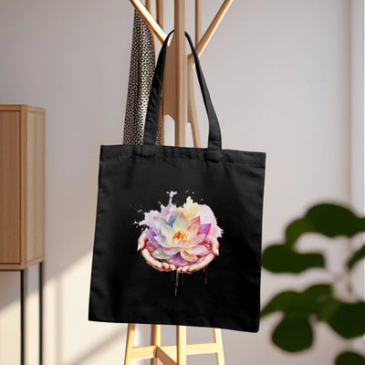 a black tote bag with a flower painted on it