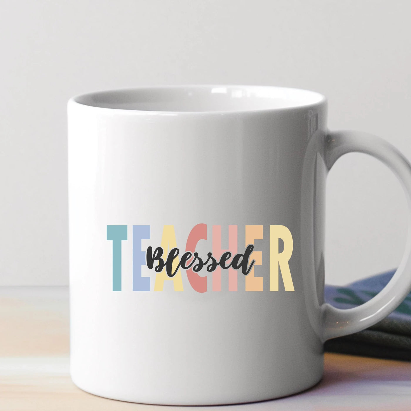 a white coffee mug with the word teacher printed on it