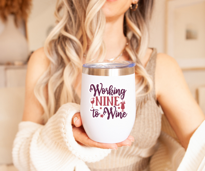 a woman holding a wine tumbler in her hand