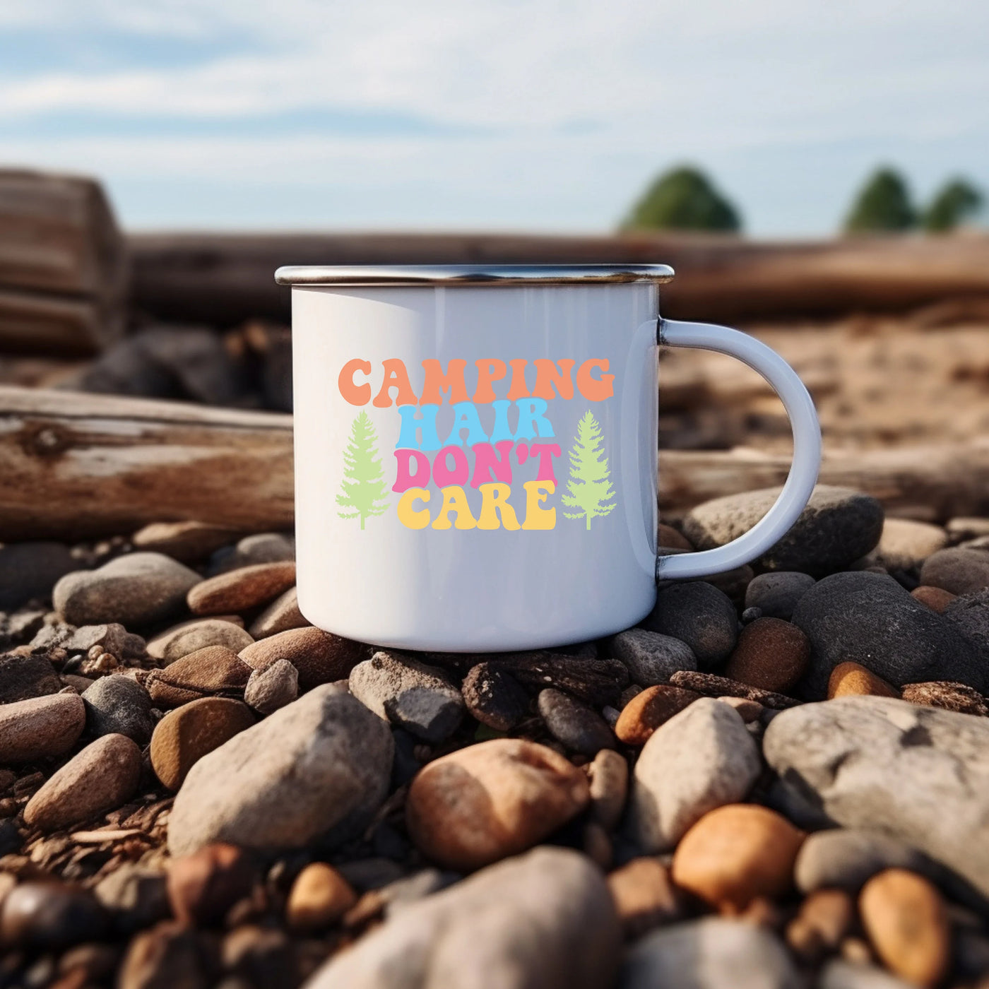 a white camper mug sitting on top of a pile of rocks