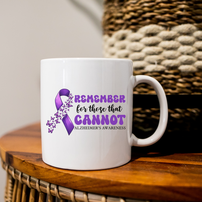 a white coffee mug with a purple ribbon on it