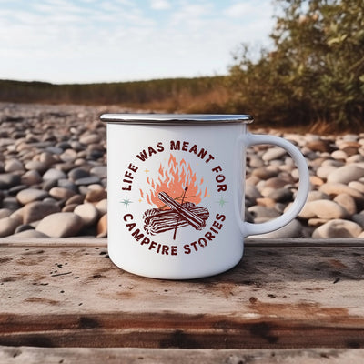 a white campfire mug sitting on top of a wooden table