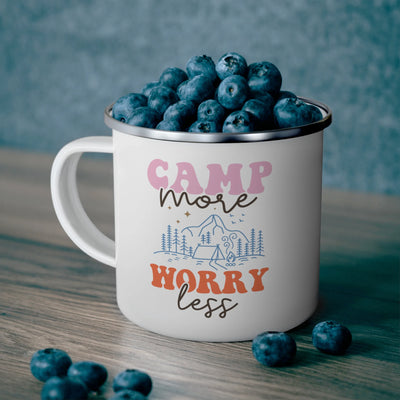 a camp mug filled with blueberries on a table