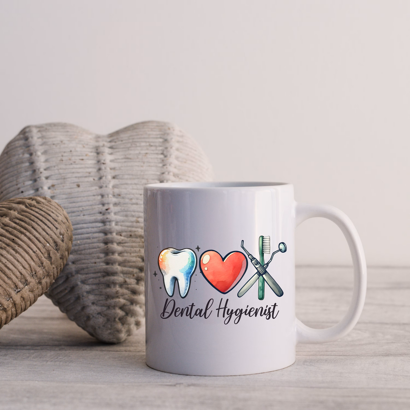 a white coffee mug with a toothbrush and a heart on it