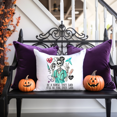 a bench with two pumpkins and a pillow on it