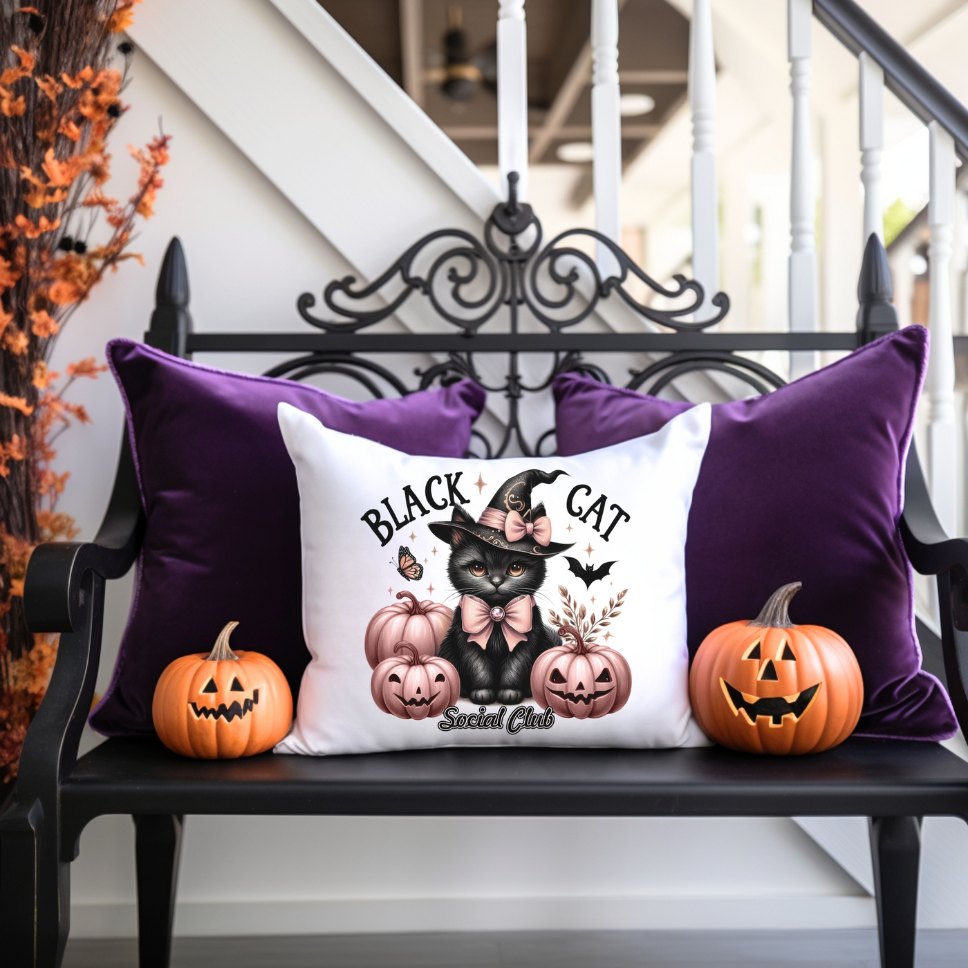 a black cat pillow sitting on top of a bench