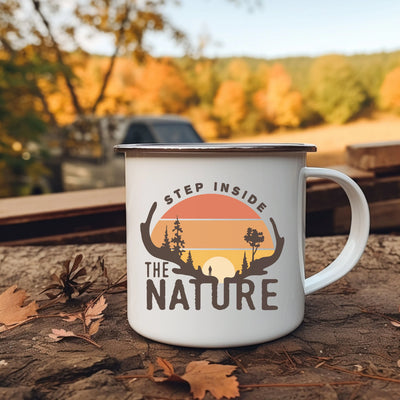 a camper mug sitting on the ground with the words, step inside the nature