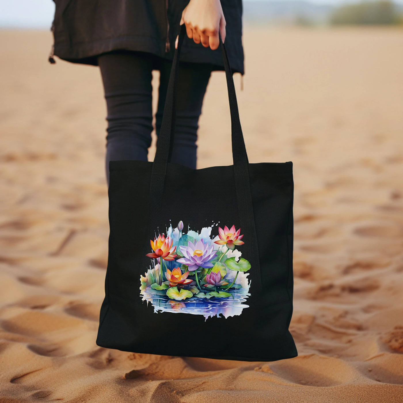 a woman carrying a black tote bag with flowers on it