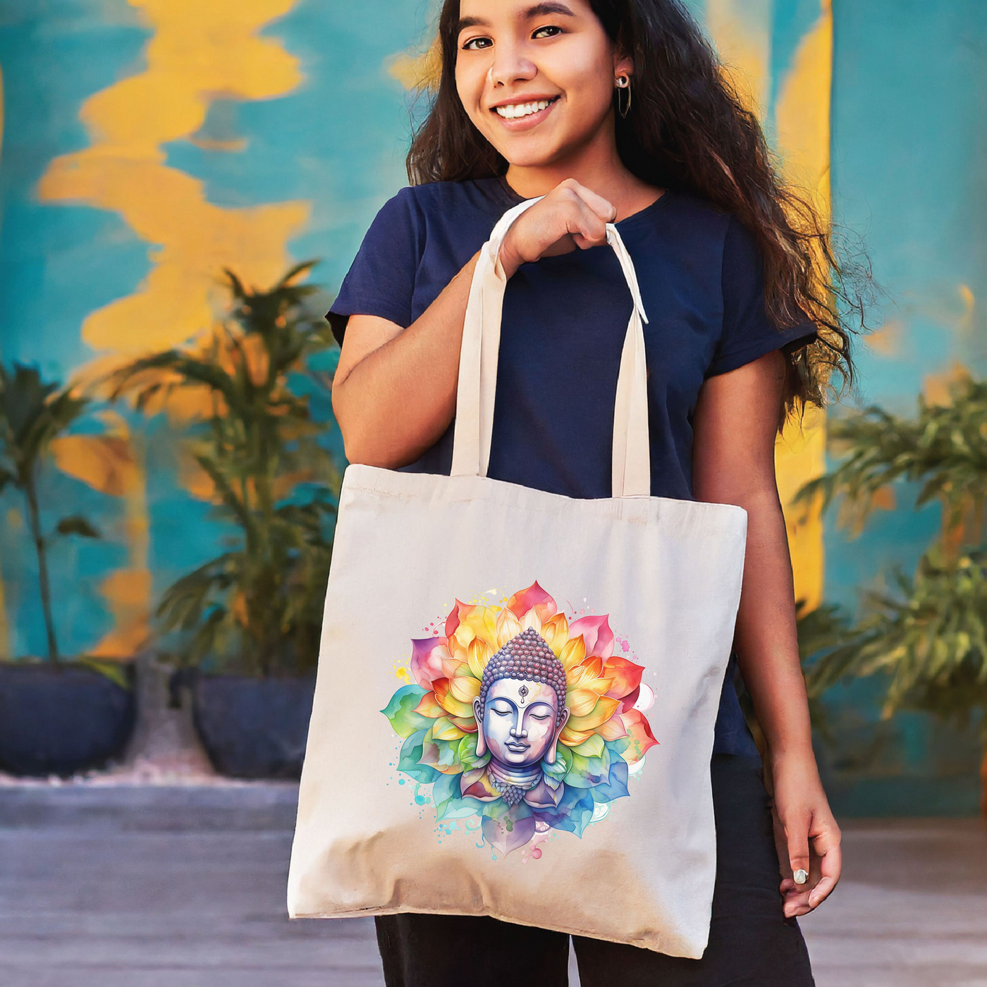 a woman holding a bag with a buddha face on it