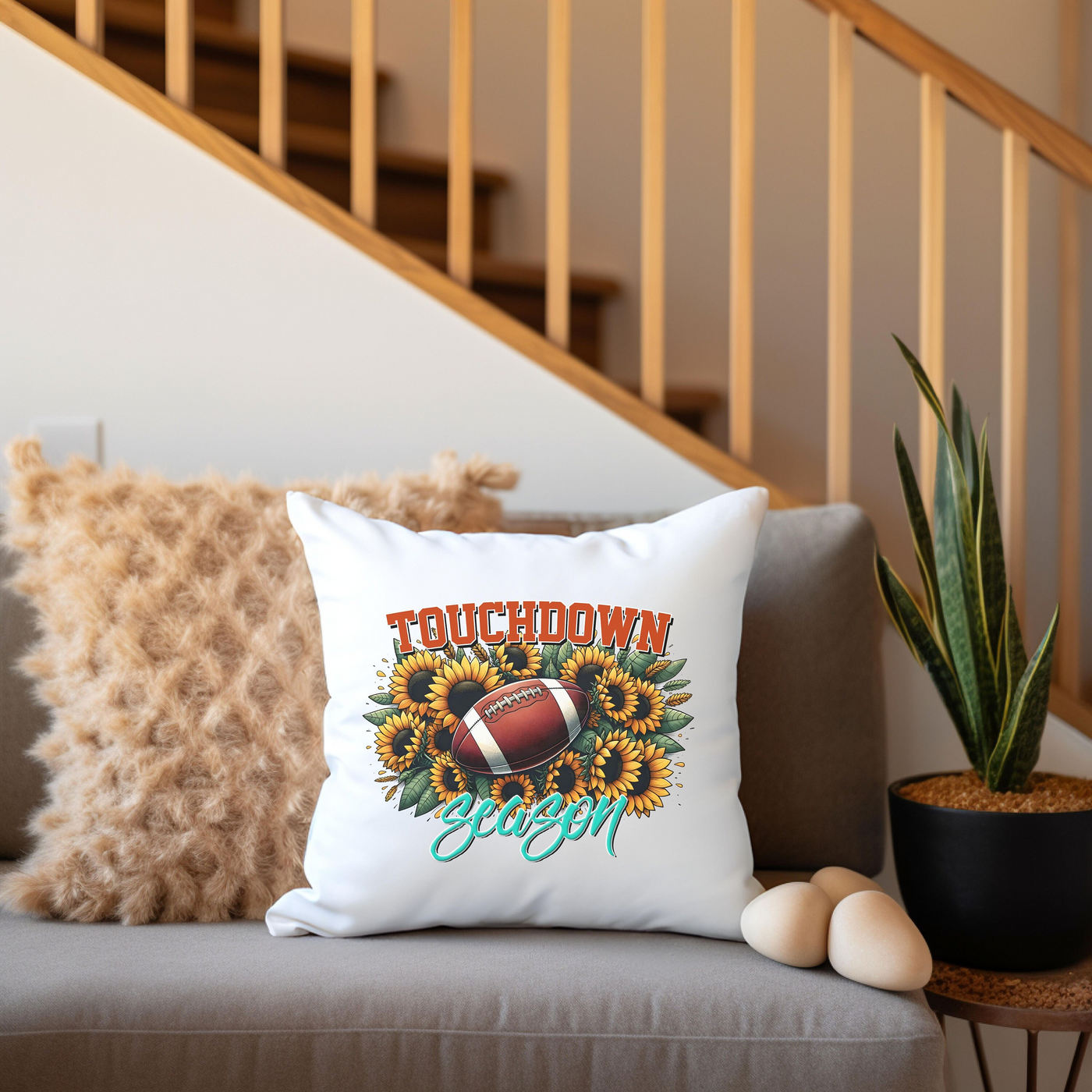 a couch with a pillow and a potted plant