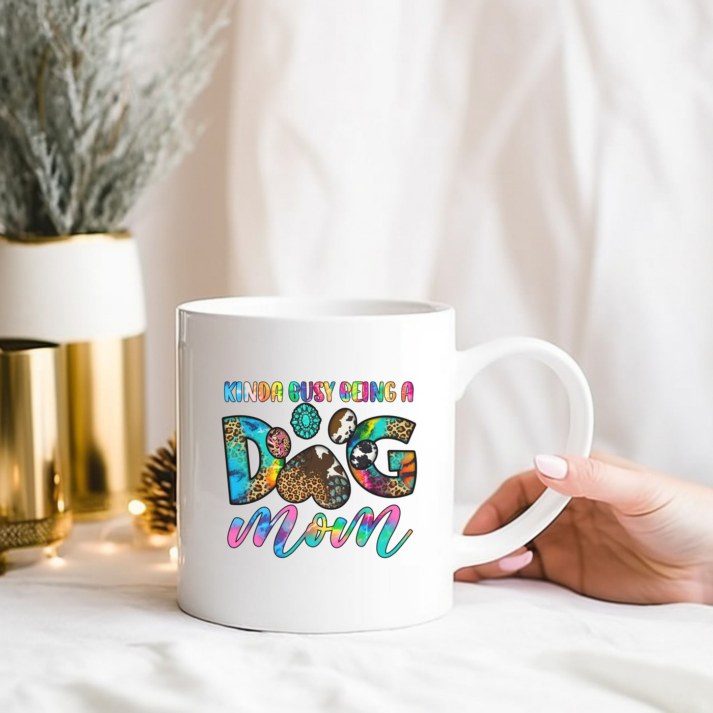 a person holding a coffee mug with the words dog mom on it