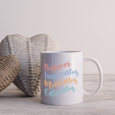 a white coffee mug sitting on top of a wooden table