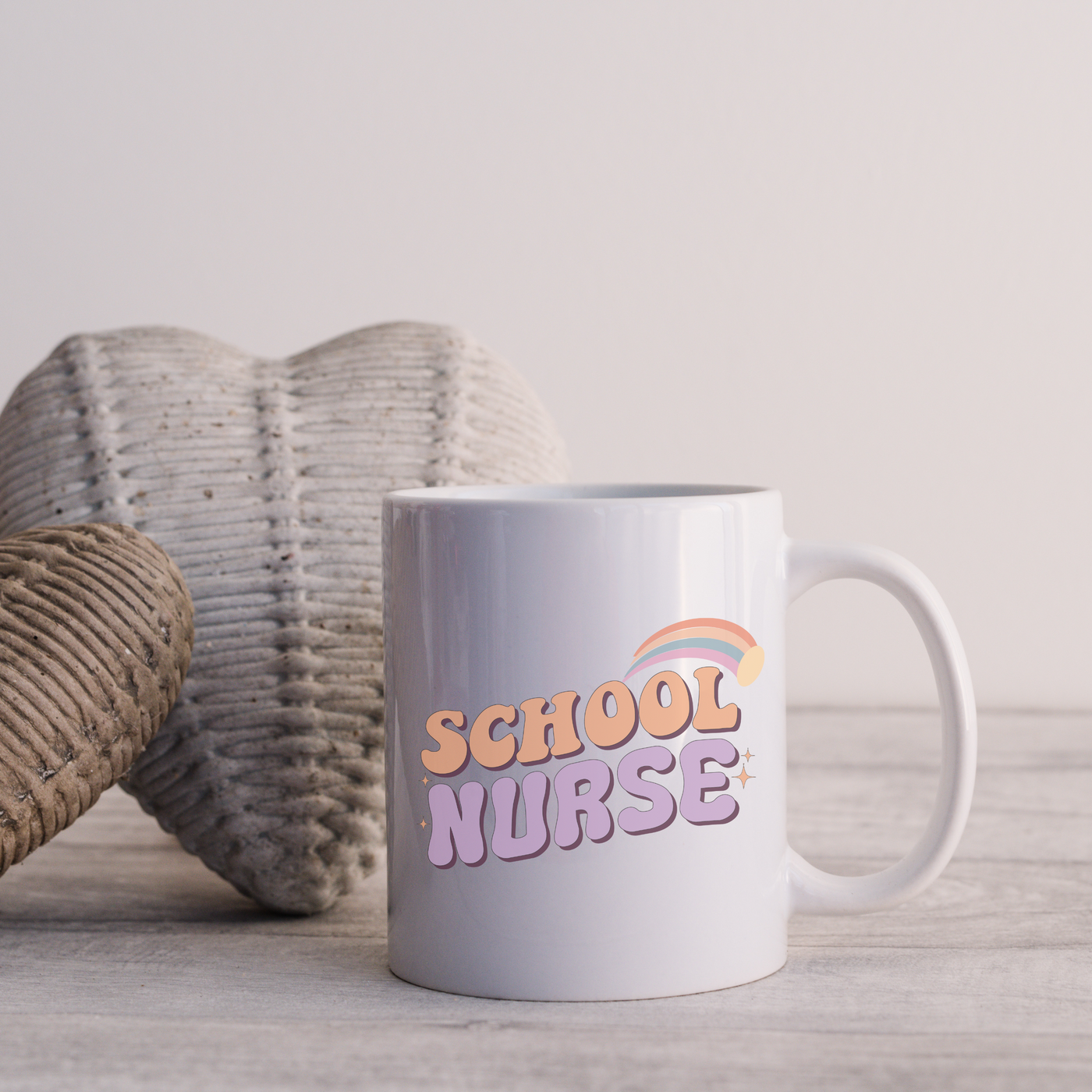 a white coffee mug sitting on top of a wooden table