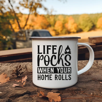 a white coffee mug sitting on top of a pile of leaves