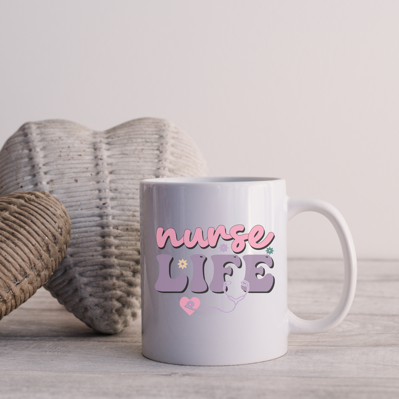 a white coffee mug sitting on top of a wooden table