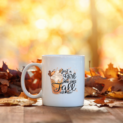 a white coffee mug sitting on top of a wooden table