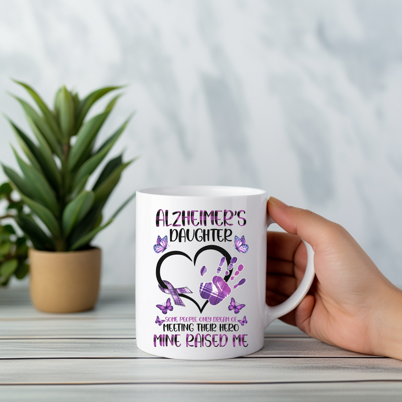 a person holding a coffee mug with a heart on it