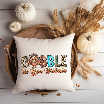 a white pillow with the words gobble til your website printed on it