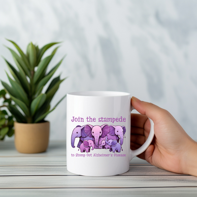 a person holding a coffee mug with elephants on it