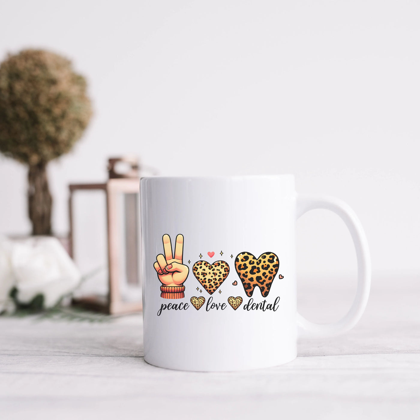 a white coffee mug with peace, love, and leopard print