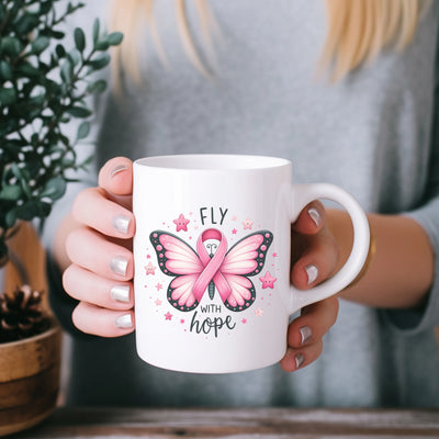 a woman holding a coffee mug with a pink butterfly on it