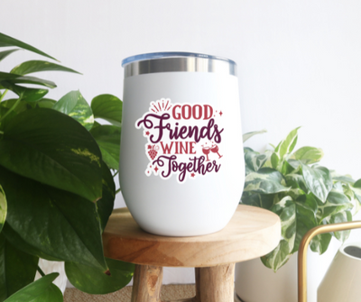 a white wine tumbler sitting on top of a wooden stool