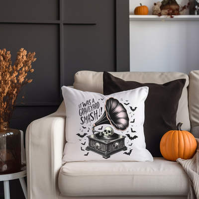 a white couch with a pillow and some pumpkins