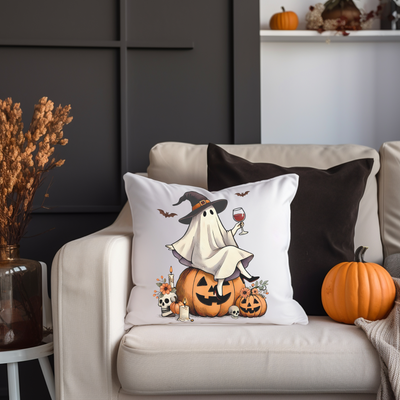 a white couch with a halloween pillow on it