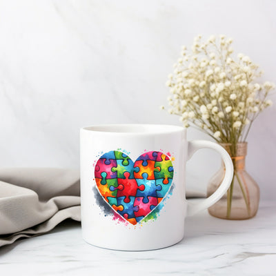 a coffee mug with a puzzle heart on it