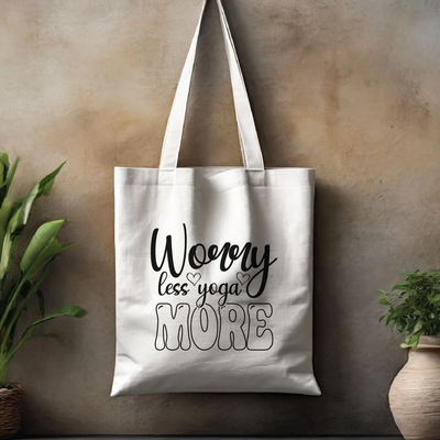 a white tote bag hanging on a wall next to a potted plant