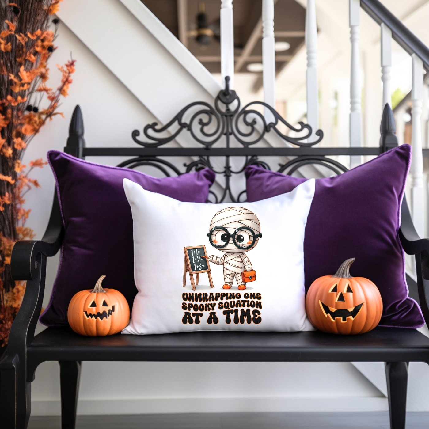 a bench with two pumpkins and a pillow on it