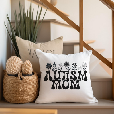 a pillow with the word autism on it next to a basket with a pair of