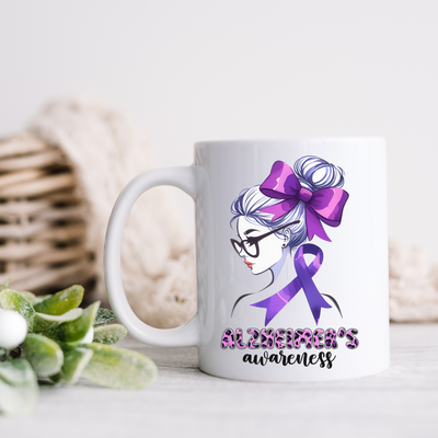 a white coffee mug with a purple ribbon on it