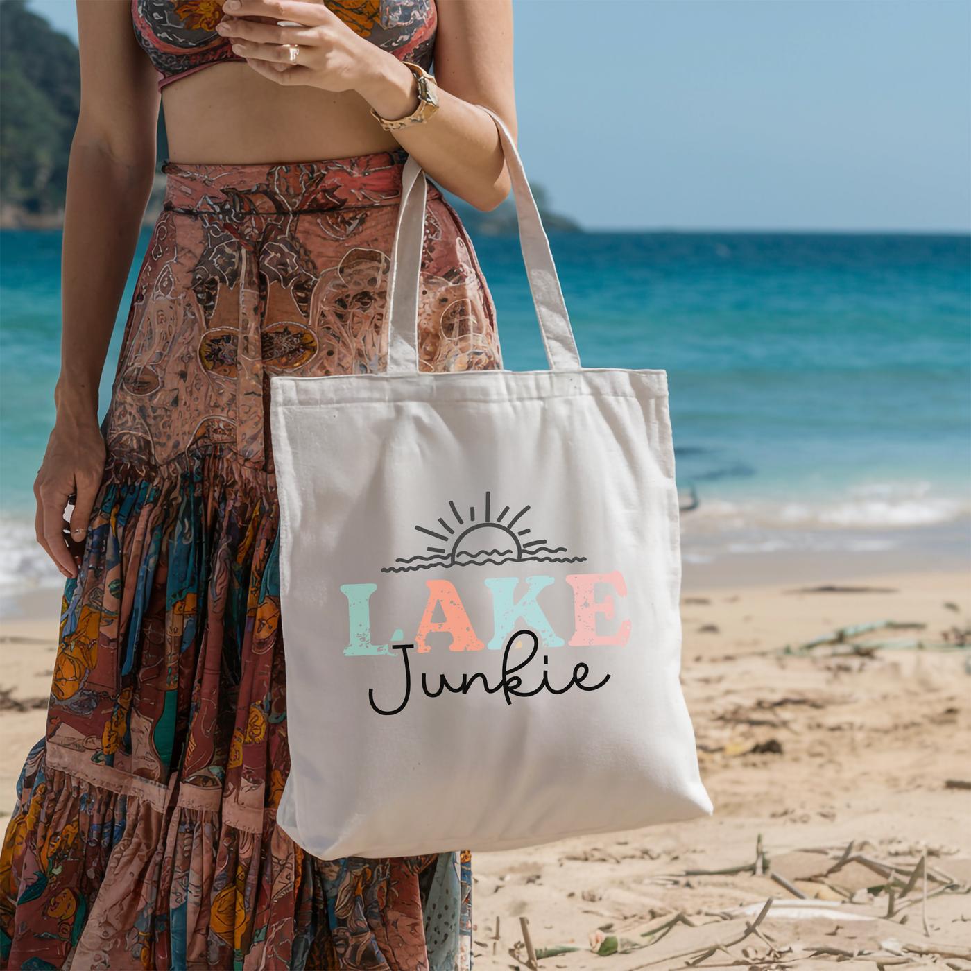 a woman standing on a beach holding a bag