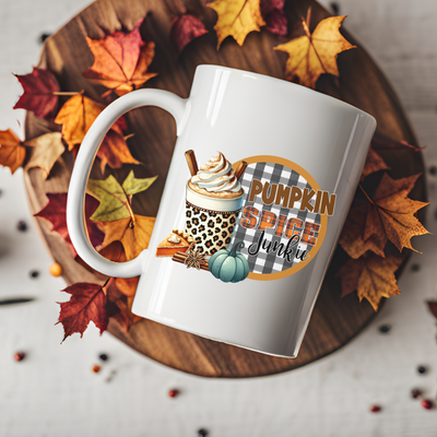 a white coffee mug with a pumpkin spice design on it